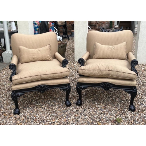 329 - A PAIR OF GEORGE II STYLE LIBRARY OPEN ARMCHAIRS
The ebonised frames upholstered in pale yellow, aca... 