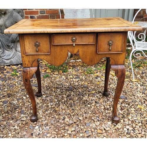 338 - AN EARLY 18TH CENTURY WALNUT LOWBOY
The herringbone inlaid top above three drawers with original tea... 