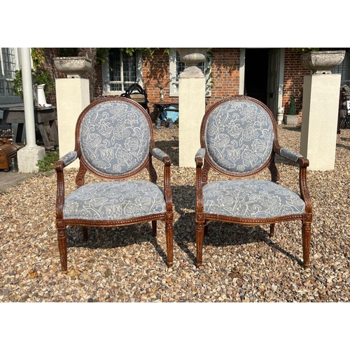 339 - A PAIR OF LATE 19TH CENTURY FRENCH CARVED WALNUT SPOONBACK OPEN ARMCHAIRS
In pale blue floral uphols... 