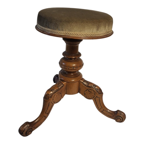 342 - A 19TH CENTURY WALNUT ADJUSTABLE PIANO STOOL
Having an upholstered cushion, telescopic brass screw m... 