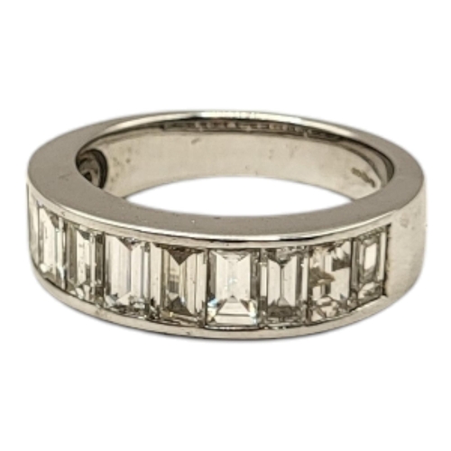 79 - AN 18CT WHITE GOLD AND DIAMOND HALF ETERNITY RING
Having a row of baguette cut stones in a plain des... 