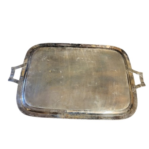 147 - A LARGE EARLY 20TH CENTURY SILVER PLATED SERVING TRAY
Twin handles with floral decoration and gadroo... 