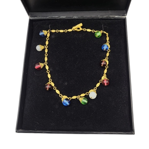 135 - LULU GUINNESS, A VINTAGE LIPS YELLOW METAL AND COLOURED GLASS NECKLACE
Set with multi coloured glass... 