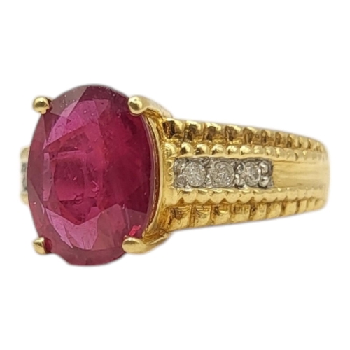 14 - A VINTAGE 18CT GOLD, RUBY AND DIAMOND RING
The single oval cut ruby with diamond set shoulders.
(rub... 