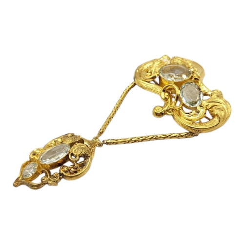 2 - A 19TH CENTURY YELLOW METAL AND AQUAMARINE BROOCH
Set with oval cut stones in a scrolled design.
(ap... 