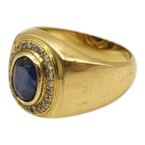 5 - A VINTAGE 18CT GOLD, SAPPHIRE AND DIAMOND SIGNET RING
The central oval cut sapphire edged with diamo... 