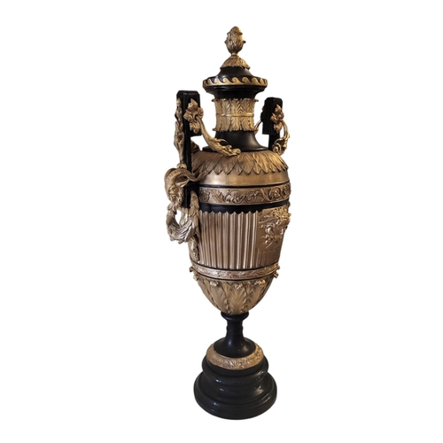 254 - A PAIR OF GRECIAN STYLE BRONZE AND GILT AMPHORA URNS
With a pineapple finial sitting above a fluted ... 