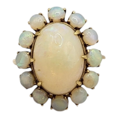 1 - A VINTAGE YELLOW METAL AND OPAL RING
The central oval cut opal edged with round cut opals.
(central ... 