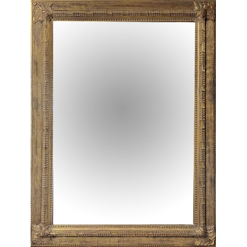 307 - A LARGE 20TH CENTURY GILT FRAMED MIRROR 
Engraved scrolled decoration to corners and bevelled glass ... 