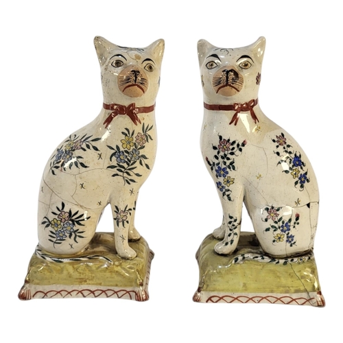 352 - A PAIR OF VICTORIAN POTTERY CAT FIGURES
Seated pose with floral decoration and cushion to base.
(app... 