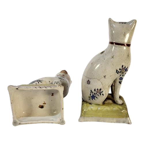 352 - A PAIR OF VICTORIAN POTTERY CAT FIGURES
Seated pose with floral decoration and cushion to base.
(app... 