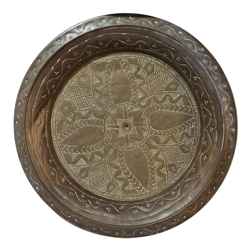 397 - A LARGE ASIAN COPPER CHARGER DISH
Shallow form with engraved decoration.
(approx 49cm)

Condition: g... 