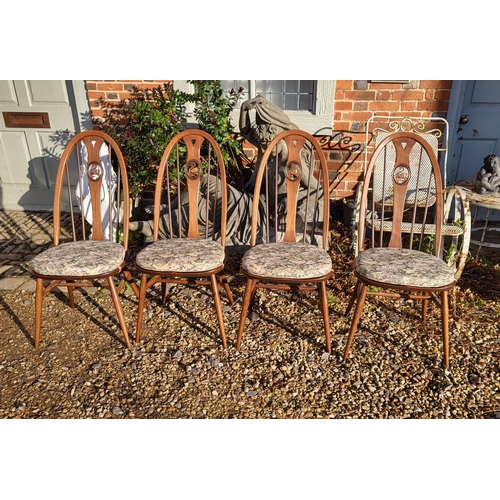 419 - A SET OF FOUR VINTAGE ERCOL TEAK ‘SWAN BACK’ DINING CHAIRS
Having upholstery cushions.

Condition: g... 