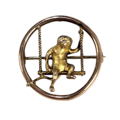 427 - AN EARLY 20TH CENTURY 9CT GOLD MONKEY PENDANT
Pierced circular design with a monkey on a swing.
(app... 