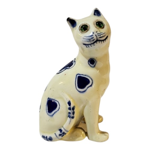 373 - A GALLE OF NANCY STYLE FAIENCE MASONIC MODEL OF A SEATED CAT, CIRCA 1900 - 1920
With blue painted he... 