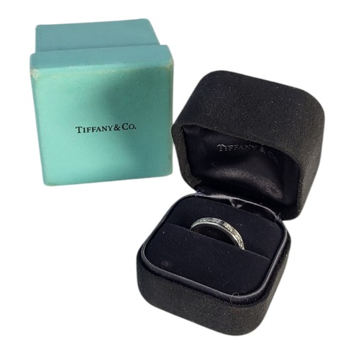 412A - TIFFANY AND CO., A PLATINUM .950 HALF ETERNITY RING
Set with baguette and round brilliant cut diamon... 