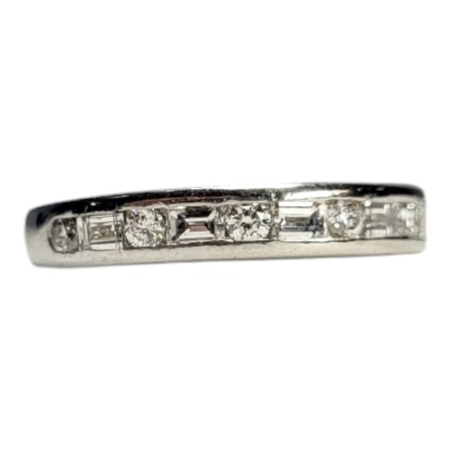 412A - TIFFANY AND CO., A PLATINUM .950 HALF ETERNITY RING
Set with baguette and round brilliant cut diamon... 