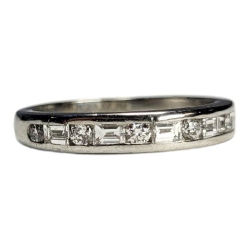 412A - TIFFANY AND CO., A PLATINUM .950 HALF ETERNITY RING
Set with baguette and round brilliant cut diamon... 