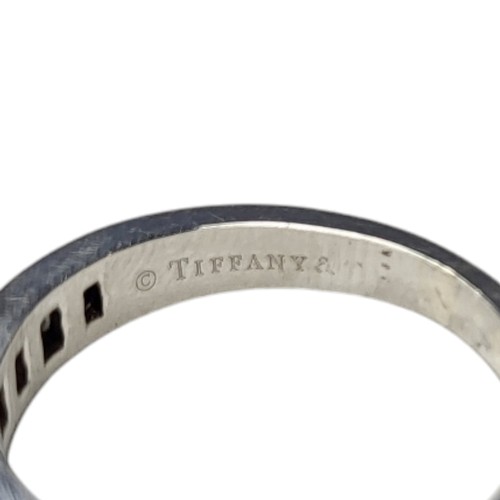 412A - TIFFANY AND CO., A PLATINUM .950 HALF ETERNITY RING
Set with baguette and round brilliant cut diamon... 