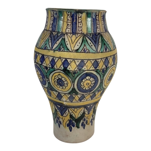 104 - A LATE 19TH CENTURY PERSIAN IZNIK STYLE FAIENCE EARTHENWARE ARABESQUE VASE
Overglaze painted with sy... 