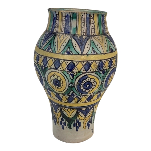 104 - A LATE 19TH CENTURY PERSIAN IZNIK STYLE FAIENCE EARTHENWARE ARABESQUE VASE
Overglaze painted with sy... 