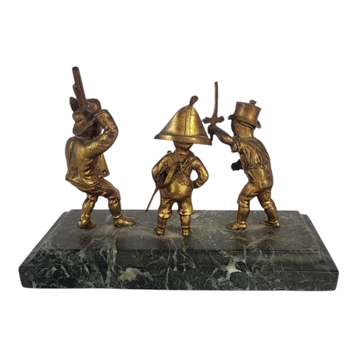 130 - AN EARLY 20TH CENTURY GILT BRONZE AND MARBLE GROUP STATUE
Three children at play wearing military at... 