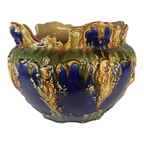 137 - A LARGE VICTORIAN MAJOLICA POTTERY JARDINIÈRE
Having a scrolled edge and embossed decoration, marked... 