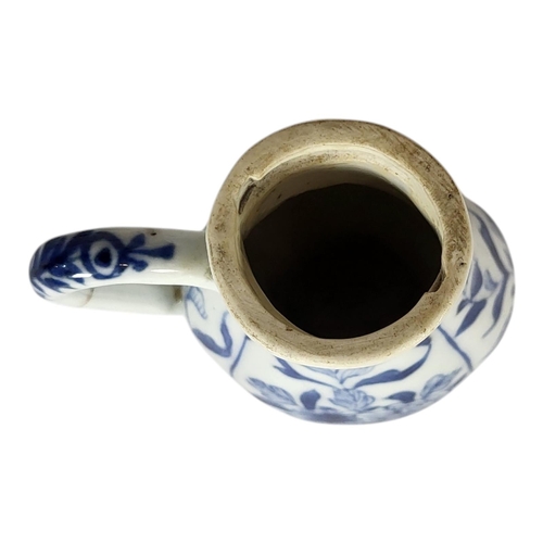 142 - AN 18TH CENTURY CHINESE EXPORT BLUE AND WHITE CYLINDRICAL TEAPOT AND COVER 
The entwined handle hard... 