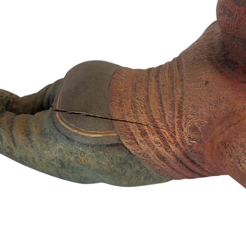 146 - A 20TH CENTURY DECORATIVE WOOD COMPOSITION MODEL OF A GARDEN KNOME RESTING
Painted in colours imitat... 