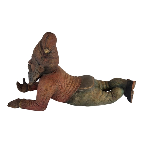 146 - A 20TH CENTURY DECORATIVE WOOD COMPOSITION MODEL OF A GARDEN KNOME RESTING
Painted in colours imitat... 