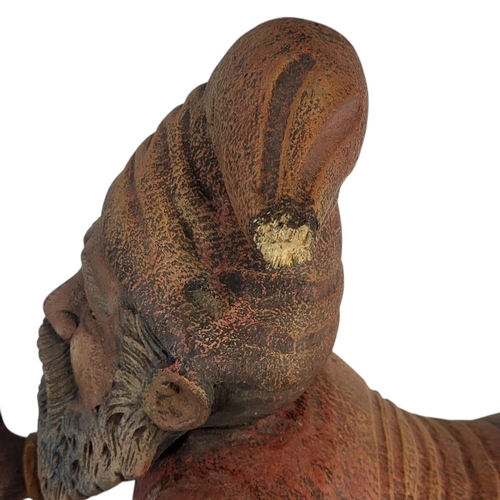 146 - A 20TH CENTURY DECORATIVE WOOD COMPOSITION MODEL OF A GARDEN KNOME RESTING
Painted in colours imitat... 