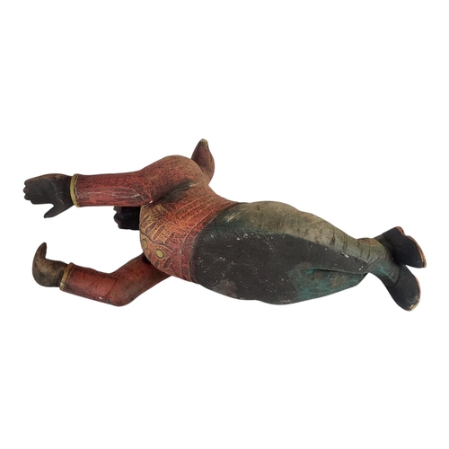 146 - A 20TH CENTURY DECORATIVE WOOD COMPOSITION MODEL OF A GARDEN KNOME RESTING
Painted in colours imitat... 