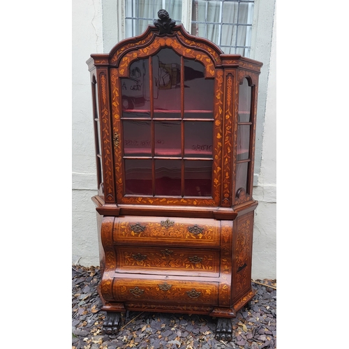 301 - A 19TH CENTURY DUTCH WALNUT AND FLORAL MARQUETRY INLAID DISPLAY CABINET ON BOMBE CHEST
The central c... 