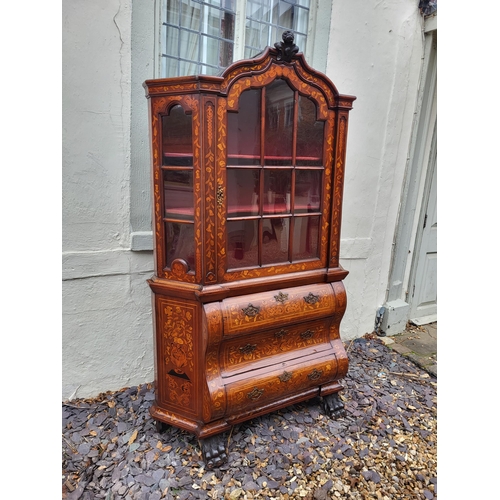 301 - A 19TH CENTURY DUTCH WALNUT AND FLORAL MARQUETRY INLAID DISPLAY CABINET ON BOMBE CHEST
The central c... 