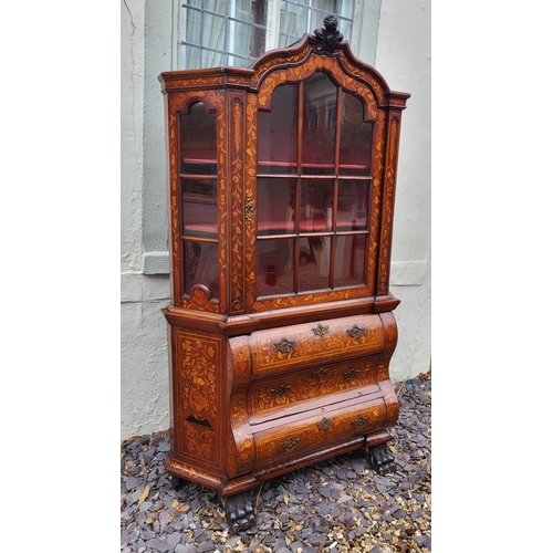 301 - A 19TH CENTURY DUTCH WALNUT AND FLORAL MARQUETRY INLAID DISPLAY CABINET ON BOMBE CHEST
The central c... 