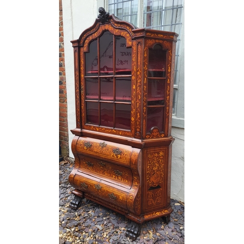 301 - A 19TH CENTURY DUTCH WALNUT AND FLORAL MARQUETRY INLAID DISPLAY CABINET ON BOMBE CHEST
The central c... 