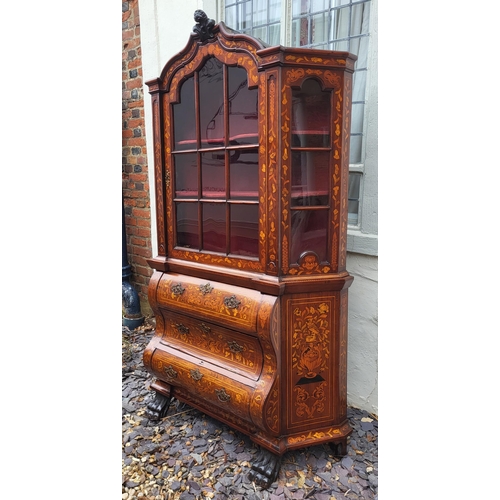 301 - A 19TH CENTURY DUTCH WALNUT AND FLORAL MARQUETRY INLAID DISPLAY CABINET ON BOMBE CHEST
The central c... 