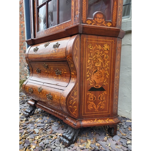 301 - A 19TH CENTURY DUTCH WALNUT AND FLORAL MARQUETRY INLAID DISPLAY CABINET ON BOMBE CHEST
The central c... 