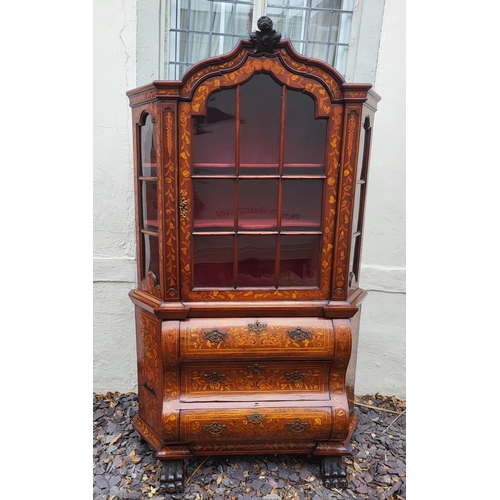 301 - A 19TH CENTURY DUTCH WALNUT AND FLORAL MARQUETRY INLAID DISPLAY CABINET ON BOMBE CHEST
The central c... 