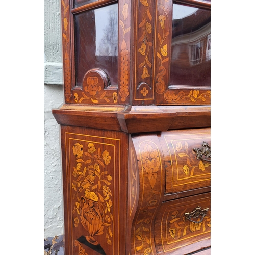 301 - A 19TH CENTURY DUTCH WALNUT AND FLORAL MARQUETRY INLAID DISPLAY CABINET ON BOMBE CHEST
The central c... 