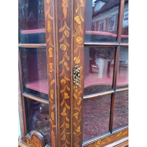 301 - A 19TH CENTURY DUTCH WALNUT AND FLORAL MARQUETRY INLAID DISPLAY CABINET ON BOMBE CHEST
The central c... 