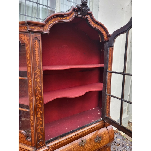 301 - A 19TH CENTURY DUTCH WALNUT AND FLORAL MARQUETRY INLAID DISPLAY CABINET ON BOMBE CHEST
The central c... 