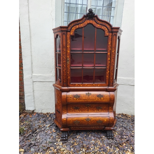 301 - A 19TH CENTURY DUTCH WALNUT AND FLORAL MARQUETRY INLAID DISPLAY CABINET ON BOMBE CHEST
The central c... 