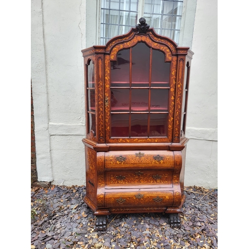 301 - A 19TH CENTURY DUTCH WALNUT AND FLORAL MARQUETRY INLAID DISPLAY CABINET ON BOMBE CHEST
The central c... 