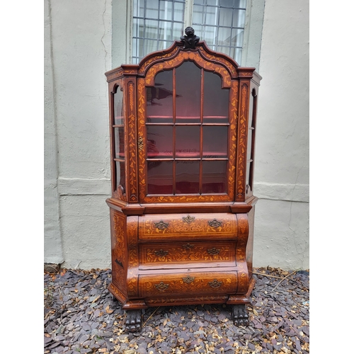 301 - A 19TH CENTURY DUTCH WALNUT AND FLORAL MARQUETRY INLAID DISPLAY CABINET ON BOMBE CHEST
The central c... 