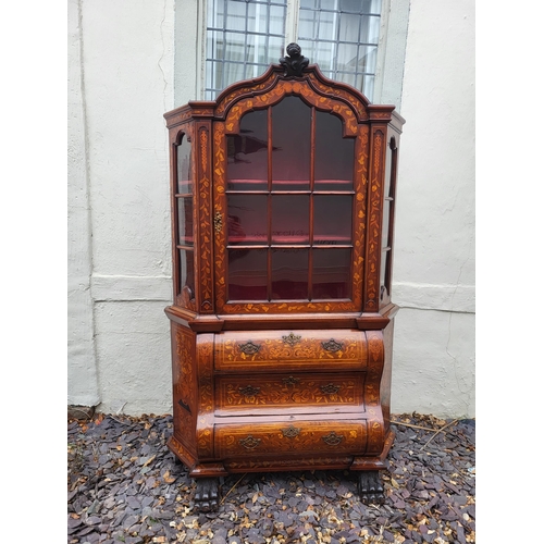 301 - A 19TH CENTURY DUTCH WALNUT AND FLORAL MARQUETRY INLAID DISPLAY CABINET ON BOMBE CHEST
The central c... 