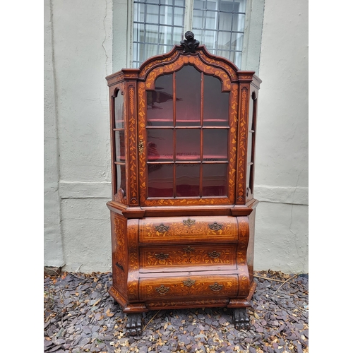 301 - A 19TH CENTURY DUTCH WALNUT AND FLORAL MARQUETRY INLAID DISPLAY CABINET ON BOMBE CHEST
The central c... 