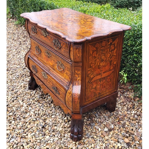 302 - A 19TH CENTURY DUTCH WALNUT AND FLORAL MARQUETRY INLAID BOMBE CHEST
The cartouche top above three lo... 