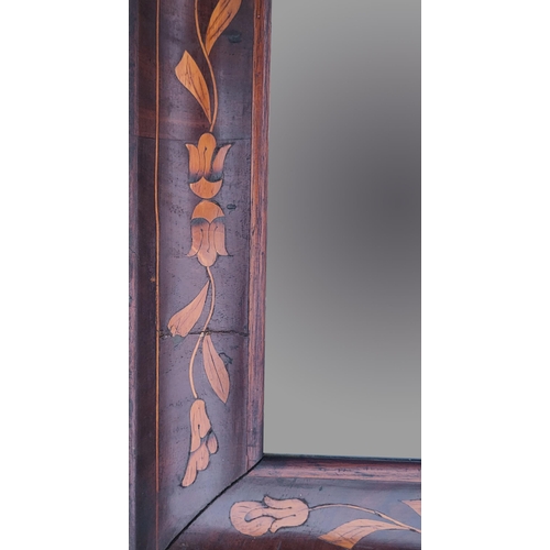 304 - A 19TH CENTURY DUTCH FLORAL MARQUETRY INLAID FRAMED MIRROR.
(39cm x 76cm)