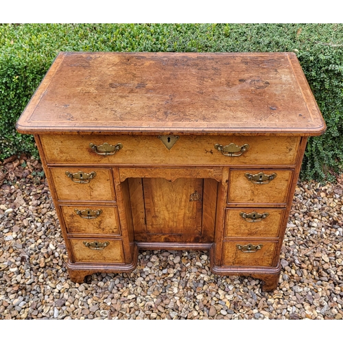 305 - AN 18TH CENTURY BURR WALNUT KNEEHOLE DESK
With an arrangement of seven drawers and central cupboard,... 